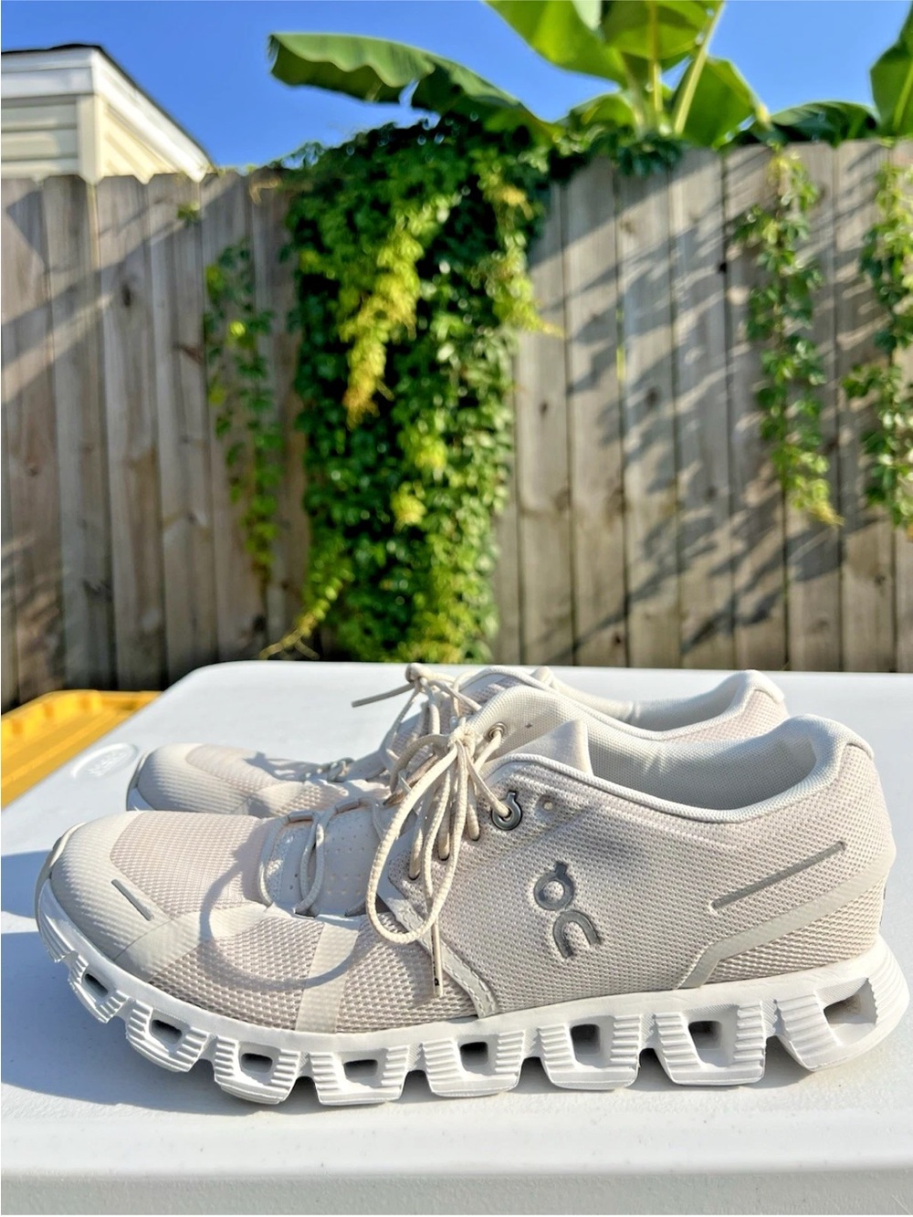 Women’s On Running sneakers in off-white and tan accents